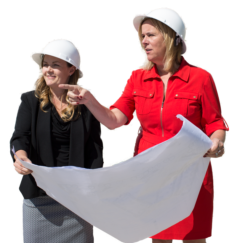 two ladies looking at blue print or floor plan of a house home pointing out to the distance wearing white hard hats looking for resouces