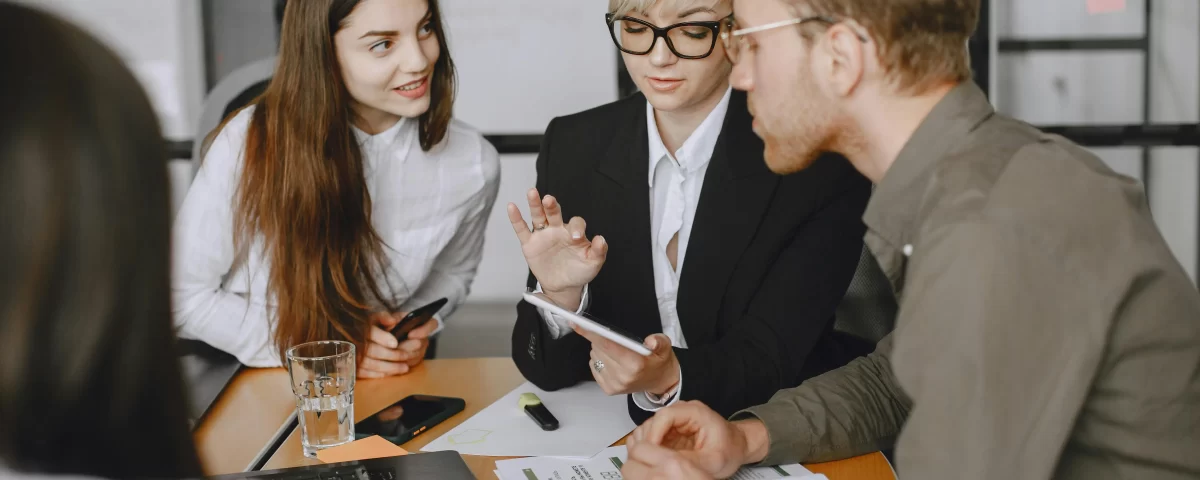 Team discussing financial reports and payment schedules during a meeting.