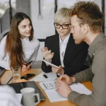 Team discussing financial reports and payment schedules during a meeting.