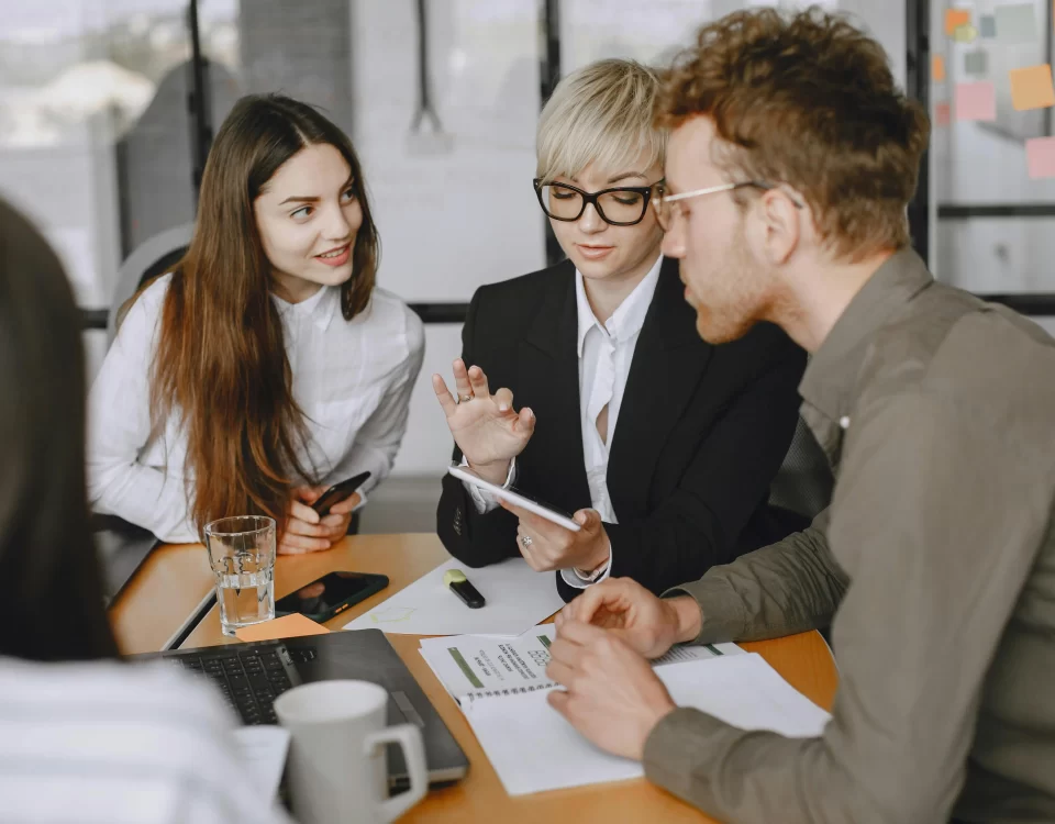 Team discussing financial reports and payment schedules during a meeting.