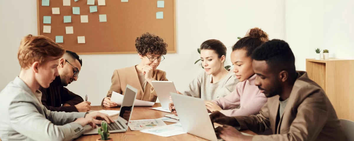 Group of professionals collaborating in a meeting to discuss community engagement strategies.