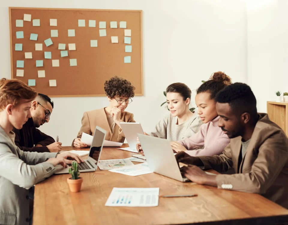 Group of professionals collaborating in a meeting to discuss community engagement strategies.