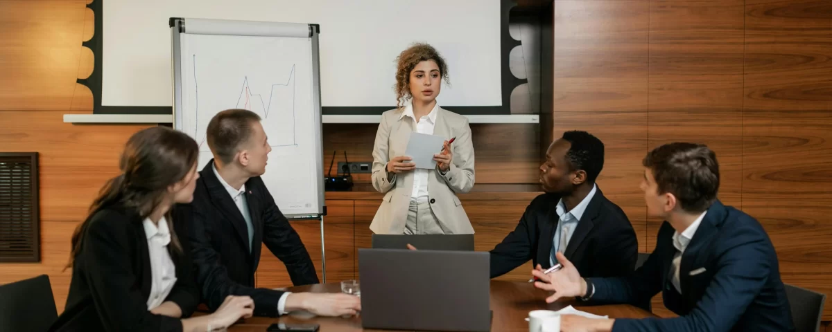 Business team in a meeting discussing strategies for delivering excellence in HOA management.