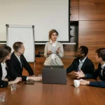 Business team in a meeting discussing strategies for delivering excellence in HOA management.