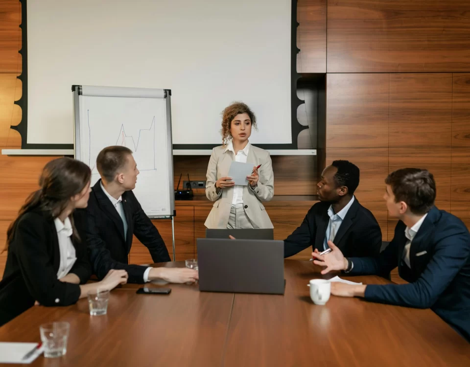 Business team in a meeting discussing strategies for delivering excellence in HOA management.