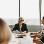 HOA board members meeting with a management company representative in a conference room.