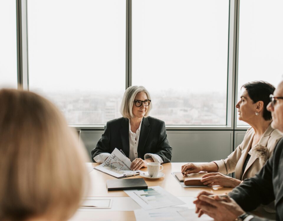 HOA board members meeting with a management company representative in a conference room.